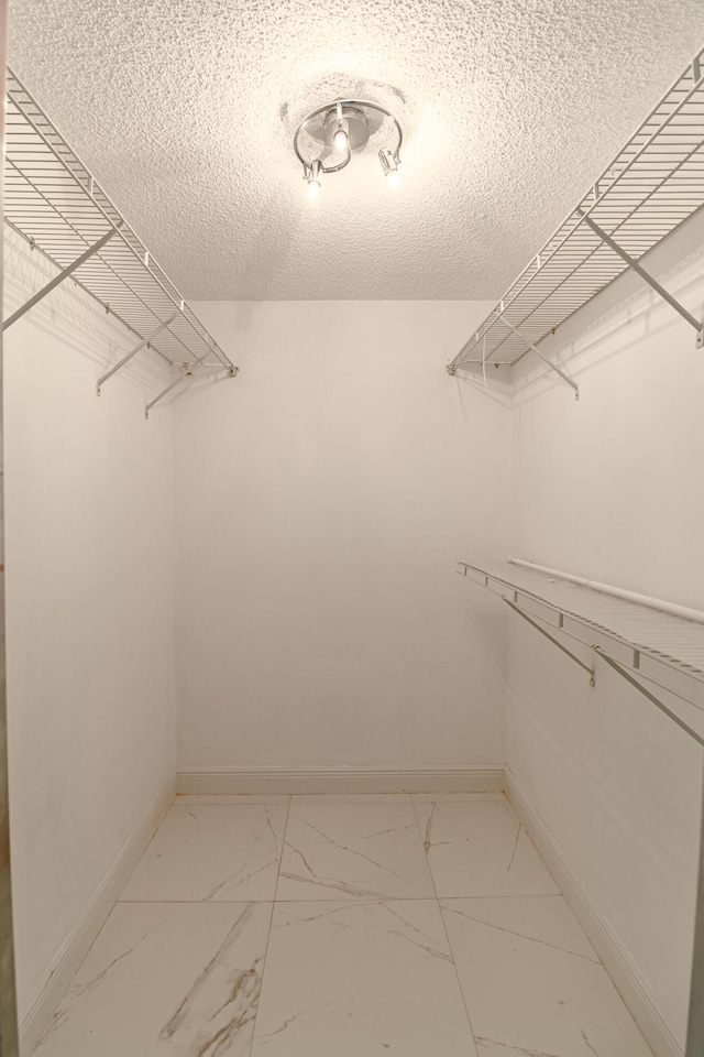 8129 Sedgewick Ct Unit 29-A, Lake Clarke Shores, FL 33406 - walk in closet featuring light marble finish flooring