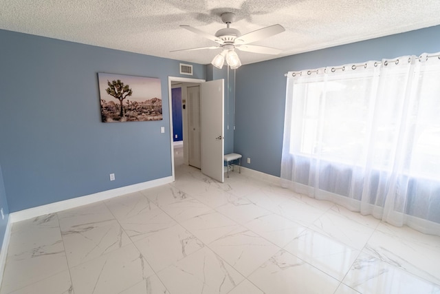 8129 Sedgewick Ct Unit 29-A, Lake Clarke Shores, FL 33406 - unfurnished room with ceiling fan, marble finish flooring, and a textured ceiling