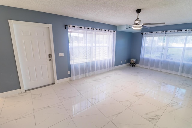 8129 Sedgewick Ct Unit 29-A, Lake Clarke Shores, FL 33406 - spare room with marble look tile flooring, a textured ceiling, and a ceiling fan