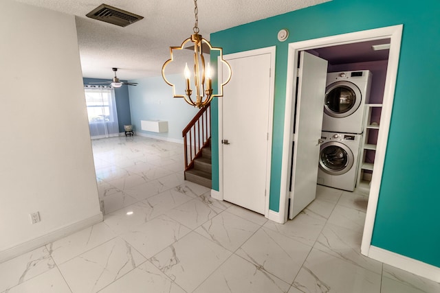 8129 Sedgewick Ct Unit 29-A, Lake Clarke Shores, FL 33406 - laundry area featuring stacked washer / dryer, marble look tiles, a chandelier, ceiling fan, and a textured ceiling