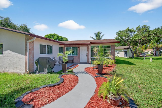 2520 SW Natura Blvd, Deerfield Beach, FL 33441 - single story home with a front lawn, brick siding, stucco siding, and a patio