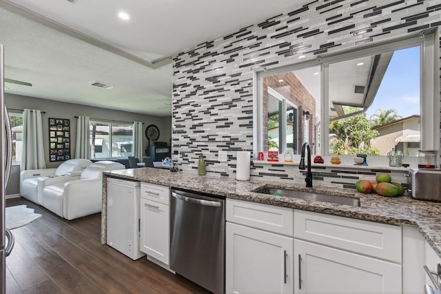 2520 SW Natura Blvd, Deerfield Beach, FL 33441 - kitchen featuring dishwasher, white cabinetry, open floor plan, dark wood-style flooring, and decorative backsplash