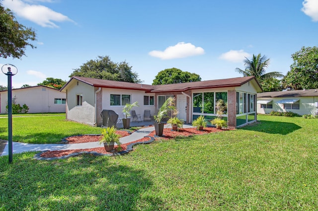 2520 SW Natura Blvd, Deerfield Beach, FL 33441 - view of front of property featuring a front lawn and stucco siding