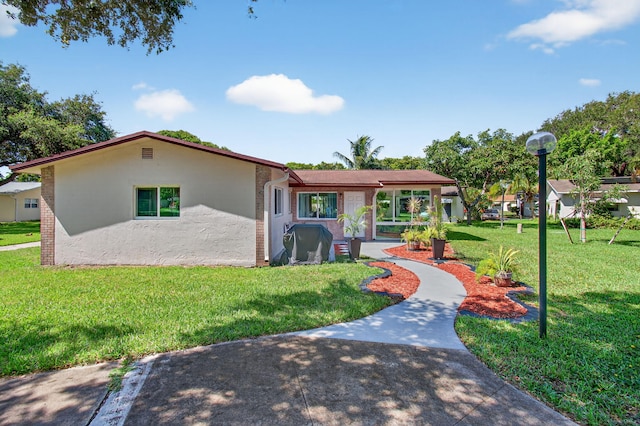 2520 SW Natura Blvd, Deerfield Beach, FL 33441 - view of front facade featuring a front lawn and stucco siding