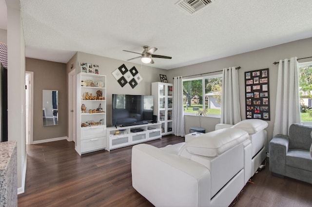 2520 SW Natura Blvd, Deerfield Beach, FL 33441 - living room featuring dark wood-style flooring, ceiling fan, and a textured ceiling