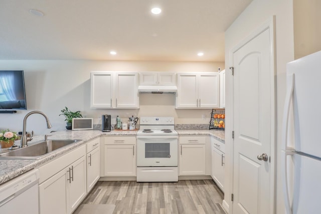 1937 SW Aguero St, Port Saint Lucie, FL 34953 - kitchen with white appliances, under cabinet range hood, white cabinets, and recessed lighting