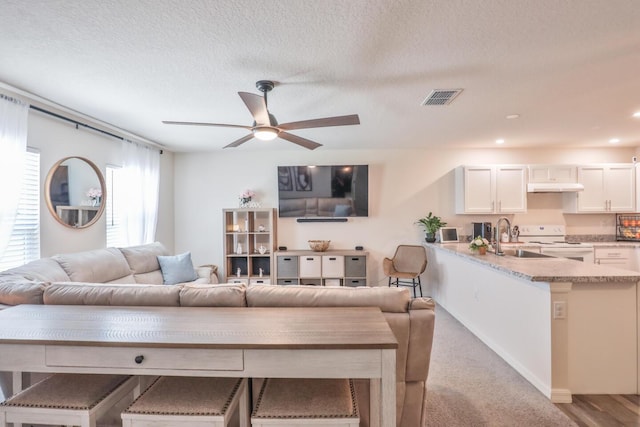 1937 SW Aguero St, Port Saint Lucie, FL 34953 - living area featuring a ceiling fan, a textured ceiling, and recessed lighting