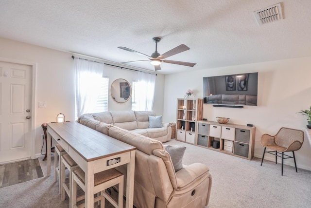 1937 SW Aguero St, Port Saint Lucie, FL 34953 - living room featuring carpet floors, ceiling fan, and a textured ceiling