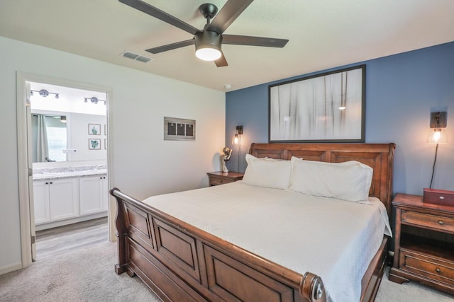 1937 SW Aguero St, Port Saint Lucie, FL 34953 - bedroom with light colored carpet, ensuite bath, and a ceiling fan