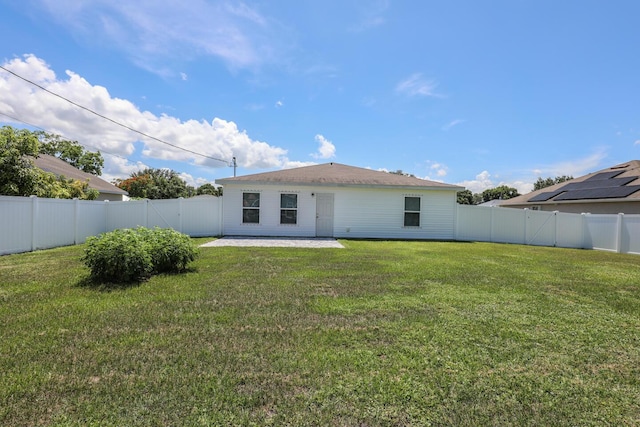 1937 SW Aguero St, Port Saint Lucie, FL 34953 - back of property featuring a fenced backyard and a patio area