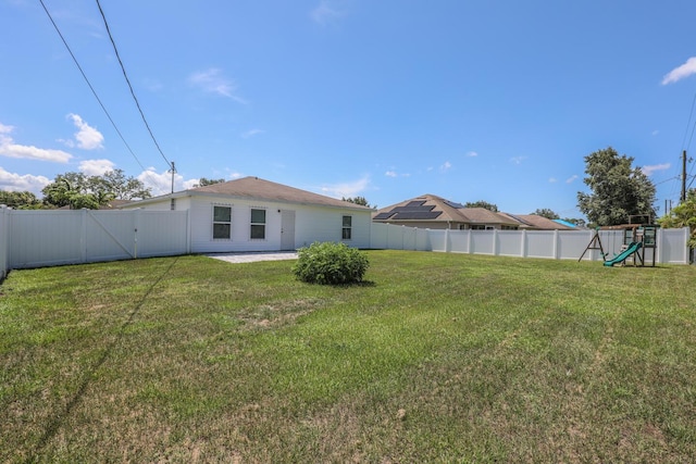 1937 SW Aguero St, Port Saint Lucie, FL 34953 - fenced backyard with a playground