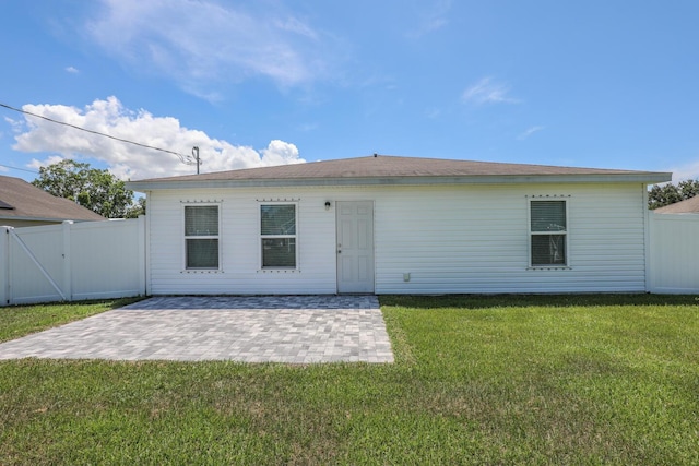 1937 SW Aguero St, Port Saint Lucie, FL 34953 - back of property featuring a patio area and a gate
