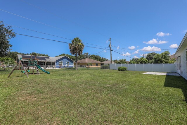 1937 SW Aguero St, Port Saint Lucie, FL 34953 - fenced backyard featuring a playground