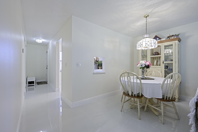 717 S US Highway 1 Unit 108, Jupiter, FL 33477 - dining space with a chandelier and a textured ceiling