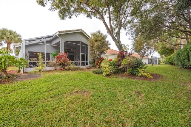 10856 Royal Caribbean Cir, Boynton Beach, FL 33437 - rear view of house featuring a lawn, stucco siding, and glass enclosure