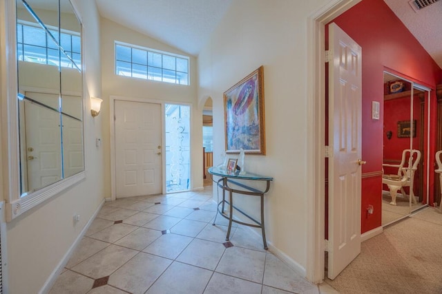 10856 Royal Caribbean Cir, Boynton Beach, FL 33437 - foyer entrance featuring arched walkways, light tile patterned flooring, and high vaulted ceiling