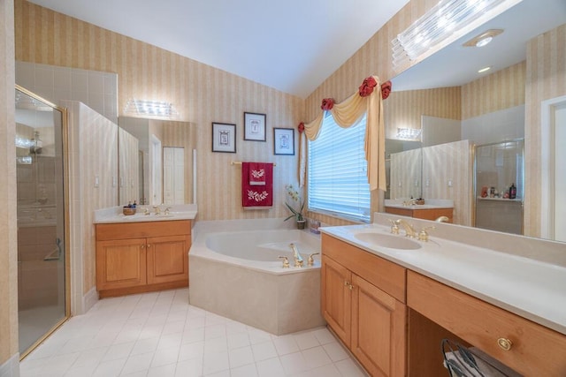 10856 Royal Caribbean Cir, Boynton Beach, FL 33437 - bathroom featuring wallpapered walls, a garden tub, a stall shower, two vanities, and vaulted ceiling