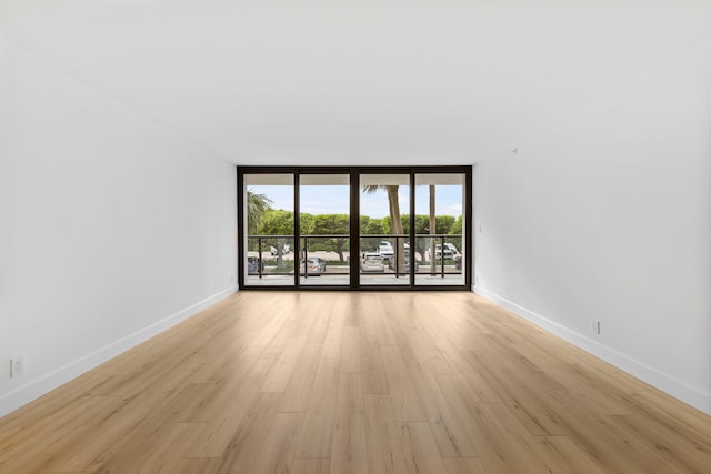 3440 S Ocean Blvd Unit 107S, Palm Beach, FL 33480 - empty room with expansive windows and light wood-style flooring