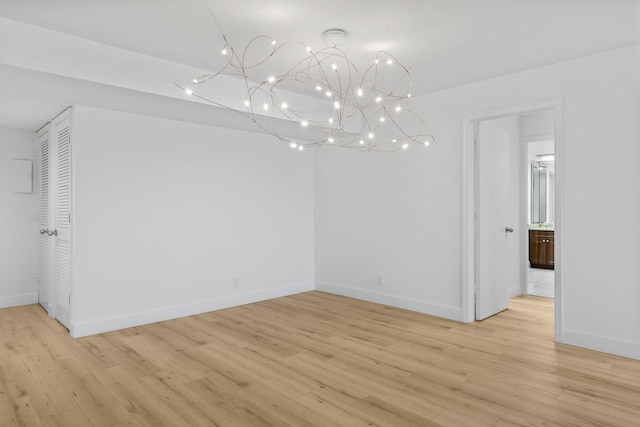 3440 S Ocean Blvd Unit 107S, Palm Beach, FL 33480 - empty room with light wood-type flooring and a chandelier
