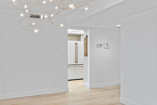 3440 S Ocean Blvd Unit 107S, Palm Beach, FL 33480 - empty room with light wood-style floors and a chandelier