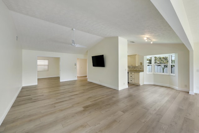 13116 SE Point O Woods Ct, Hobe Sound, FL 33455 - unfurnished living room with lofted ceiling, light wood-style floors, and ceiling fan