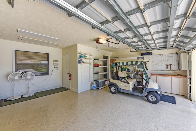 13116 SE Point O Woods Ct, Hobe Sound, FL 33455 - garage with a garage door opener and baseboards