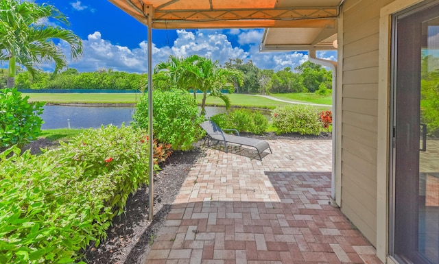 13116 SE Point O Woods Ct, Hobe Sound, FL 33455 - view of patio featuring a water view
