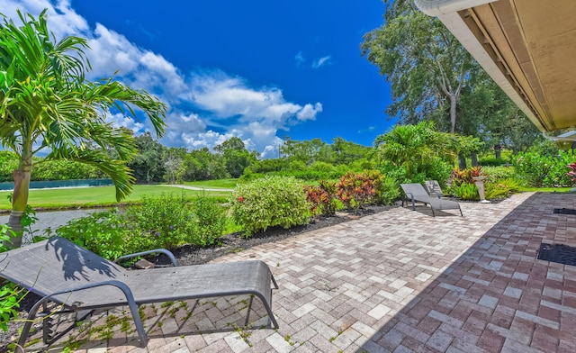 13116 SE Point O Woods Ct, Hobe Sound, FL 33455 - view of patio / terrace featuring a water view