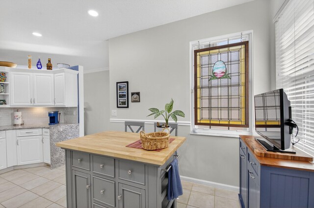 10853 Royal Caribbean Cir, Boynton Beach, FL 33437 - kitchen featuring butcher block counters, open shelves, light tile patterned floors, white cabinets, and recessed lighting