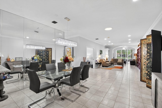 10853 Royal Caribbean Cir, Boynton Beach, FL 33437 - dining area featuring light tile patterned flooring, arched walkways, crown molding, and recessed lighting