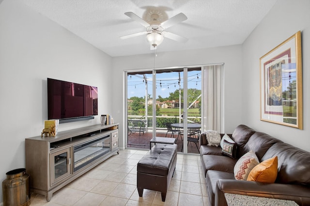 10853 Royal Caribbean Cir, Boynton Beach, FL 33437 - living room with light tile patterned floors, a ceiling fan, and a textured ceiling