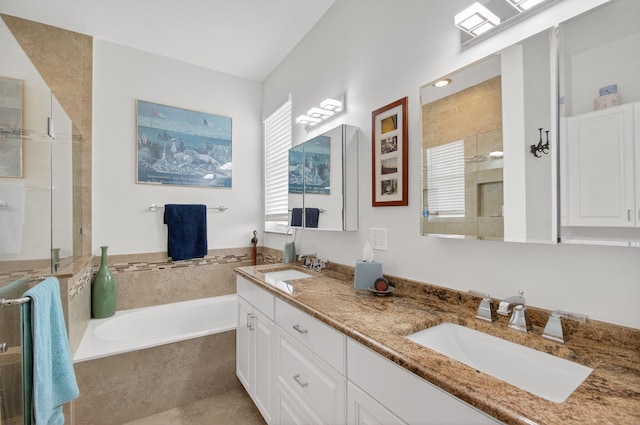 10853 Royal Caribbean Cir, Boynton Beach, FL 33437 - bathroom featuring double vanity, a garden tub, and a tile shower