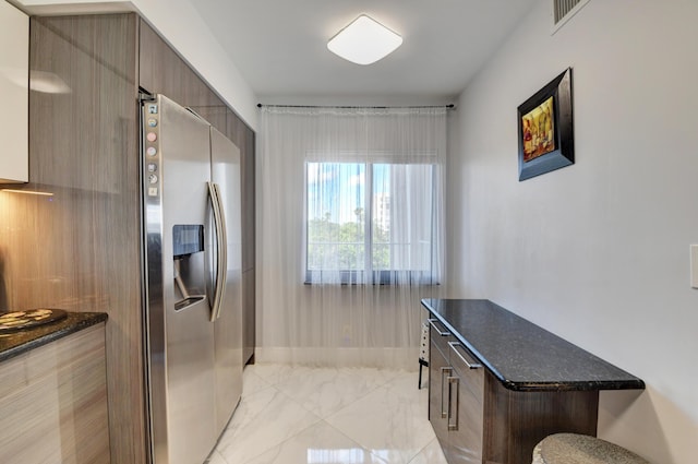7260 Kinghurst Dr Unit 401, Delray Beach, FL 33446 - kitchen with stainless steel fridge with ice dispenser, modern cabinets, light marble finish flooring, and dark stone countertops