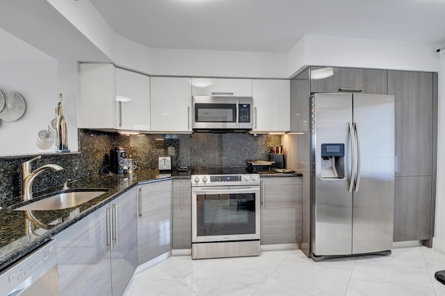 7260 Kinghurst Dr Unit 401, Delray Beach, FL 33446 - kitchen featuring appliances with stainless steel finishes, light marble finish floors, modern cabinets, dark stone countertops, and tasteful backsplash
