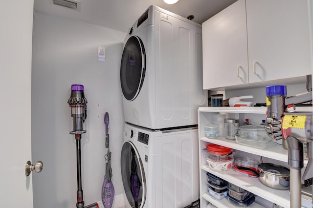 7260 Kinghurst Dr Unit 401, Delray Beach, FL 33446 - laundry area featuring stacked washer / dryer and cabinet space