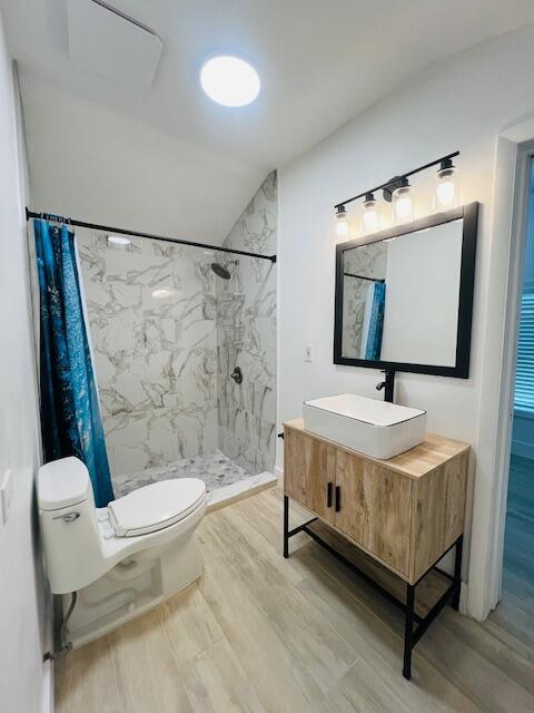 181 NE 15th Ter, Boca Raton, FL 33432 - full bath with wood finished floors, a marble finish shower, and vanity