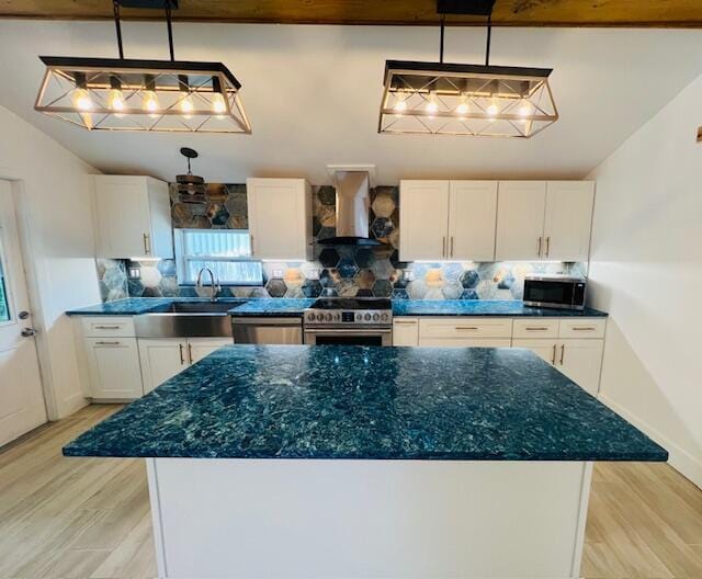 181 NE 15th Ter, Boca Raton, FL 33432 - kitchen with custom exhaust hood, stainless steel appliances, white cabinets, decorative backsplash, and a kitchen island