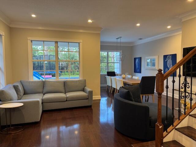 1913 Flower Dr, Palm Beach Gardens, FL 33410 - living area with stairs, dark wood-style flooring, recessed lighting, and crown molding