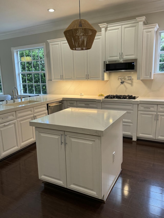 1913 Flower Dr, Palm Beach Gardens, FL 33410 - kitchen featuring crown molding, light countertops, white cabinets, appliances with stainless steel finishes, and extractor fan