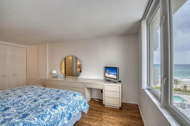 3221 S Ocean Blvd Unit 501, Highland Beach, FL 33487 - bedroom featuring wood finished floors, a textured ceiling, an office area, access to exterior, and a closet