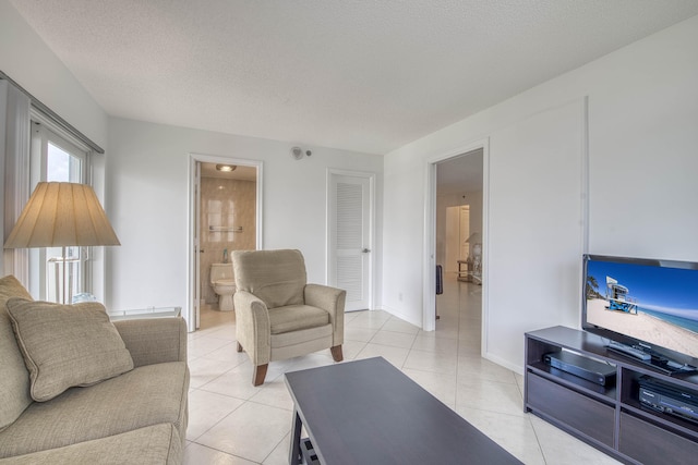 3221 S Ocean Blvd Unit 501, Highland Beach, FL 33487 - living room featuring light tile patterned floors and a textured ceiling