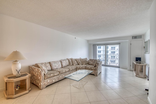 3221 S Ocean Blvd Unit 501, Highland Beach, FL 33487 - living room with a textured ceiling and light tile patterned flooring