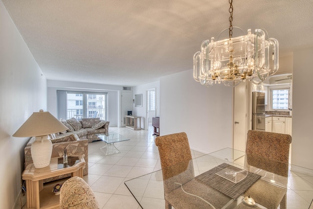3221 S Ocean Blvd Unit 501, Highland Beach, FL 33487 - dining room featuring a textured ceiling, light tile patterned floors, and a chandelier
