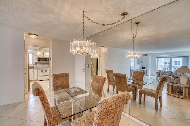 3221 S Ocean Blvd Unit 501, Highland Beach, FL 33487 - dining space featuring light tile patterned floors, a chandelier, and a textured ceiling