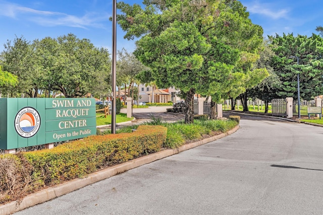 5610 Coach House Cir Unit C, Boca Raton, FL 33486 - view of asphalt street featuring curbs, street lighting, a gated entry, and a gate