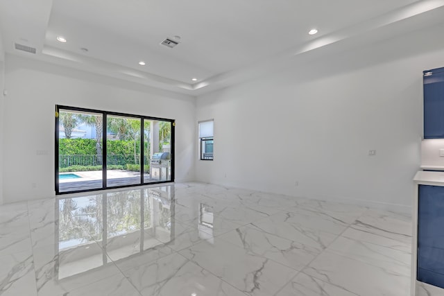 13501 Artisan Cir, Palm Beach Gardens, FL 33418 - empty room featuring marble finish floors, recessed lighting, and a raised ceiling