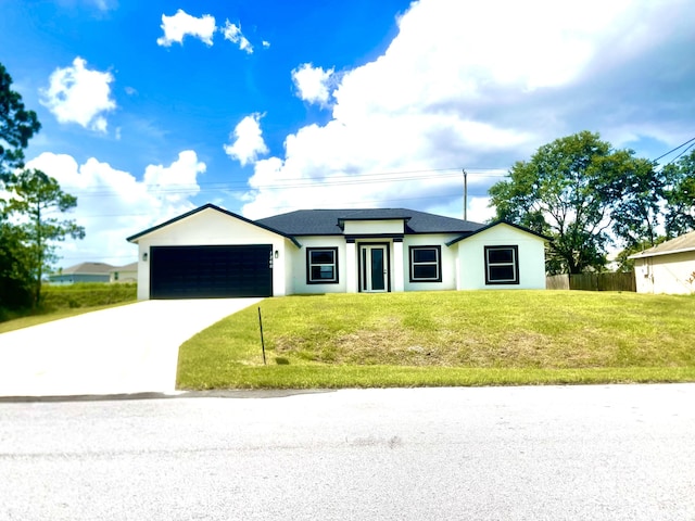 1260 Larkspur St SE, Palm Bay, FL 32909 - view of front facade featuring a garage, driveway, stucco siding, and a shingled roof