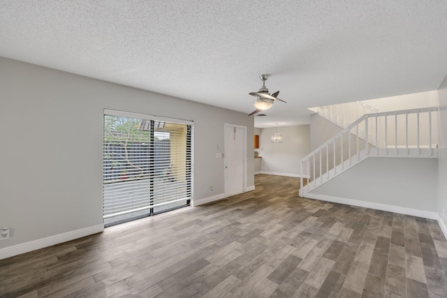 3665 Silver Lace Ln Unit 80, Boynton Beach, FL 33436 - unfurnished living room with wood finished floors, stairway, a textured ceiling, and ceiling fan