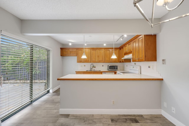 3665 Silver Lace Ln Unit 80, Boynton Beach, FL 33436 - kitchen with stainless steel microwave, range, light countertops, and a peninsula