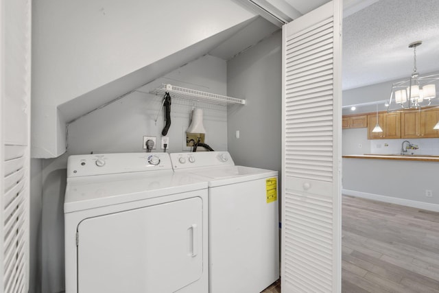 3665 Silver Lace Ln Unit 80, Boynton Beach, FL 33436 - laundry area featuring washer and clothes dryer, a chandelier, and light wood-style floors